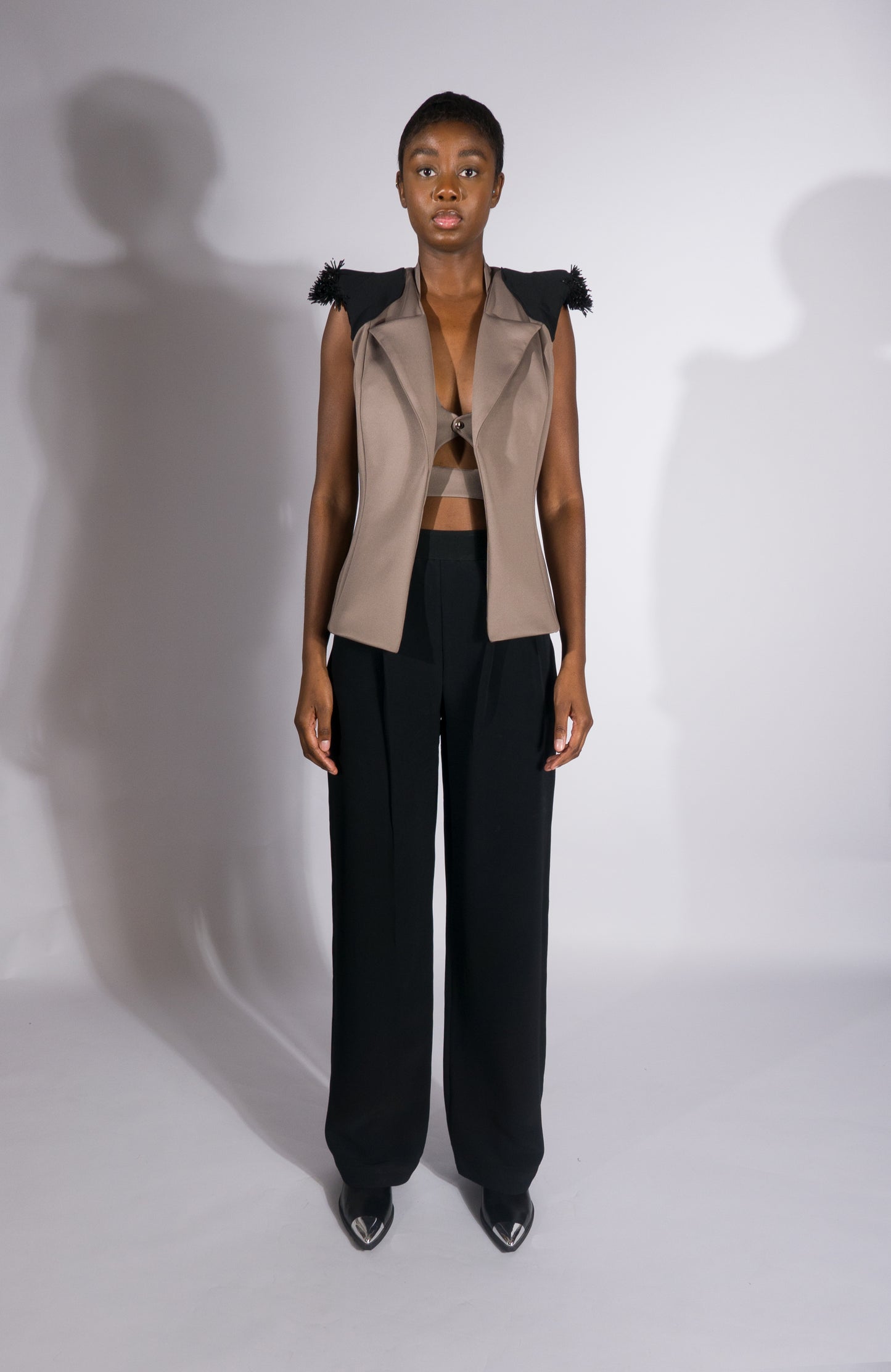 AVA, sleeveless jacket with contrasted shoulder pads and abstract embroidery